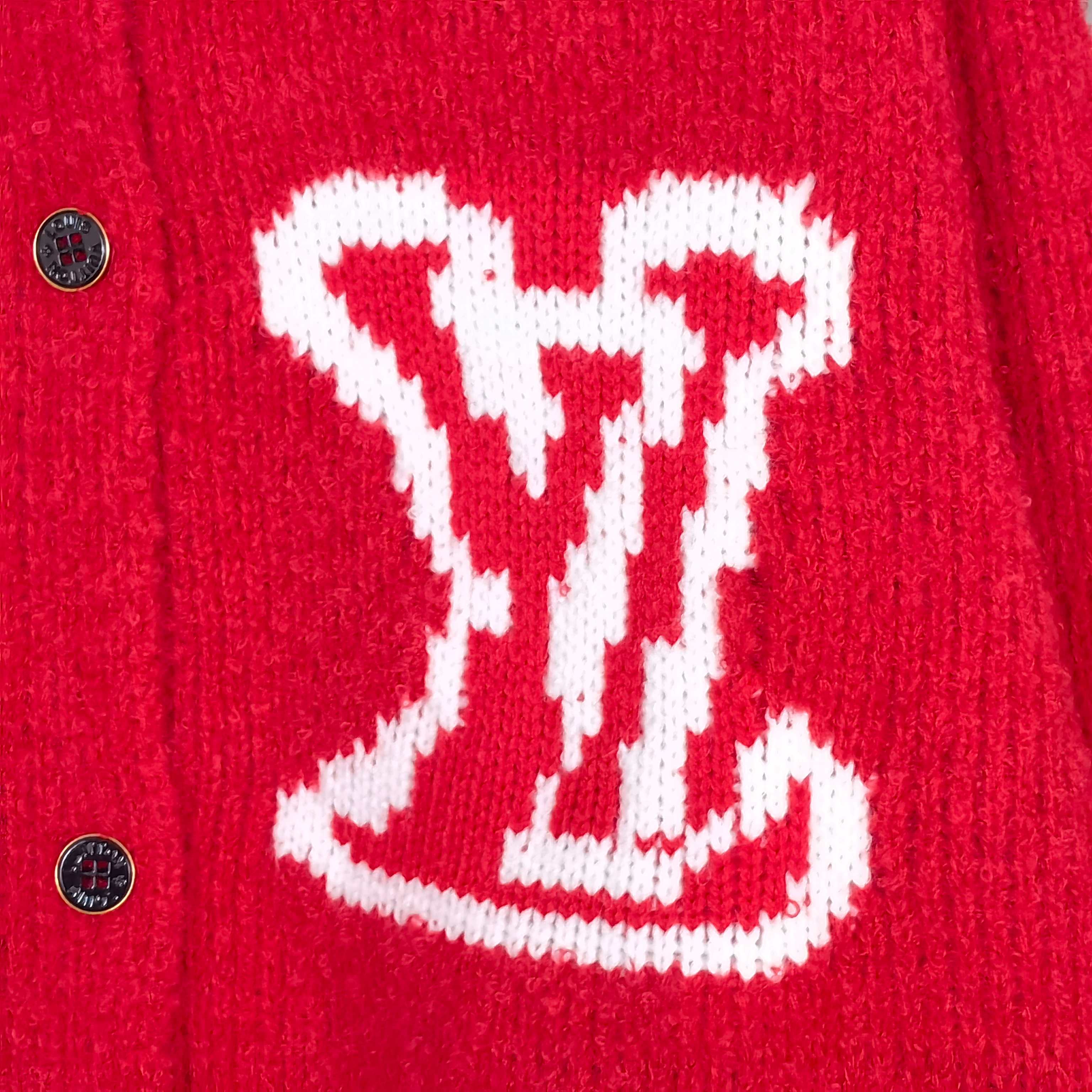 Close-up of red cardigan fabric with white LV monogram knit graphic and buttons