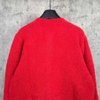 Back of red long-sleeve knit cardigan, plain design on hanger