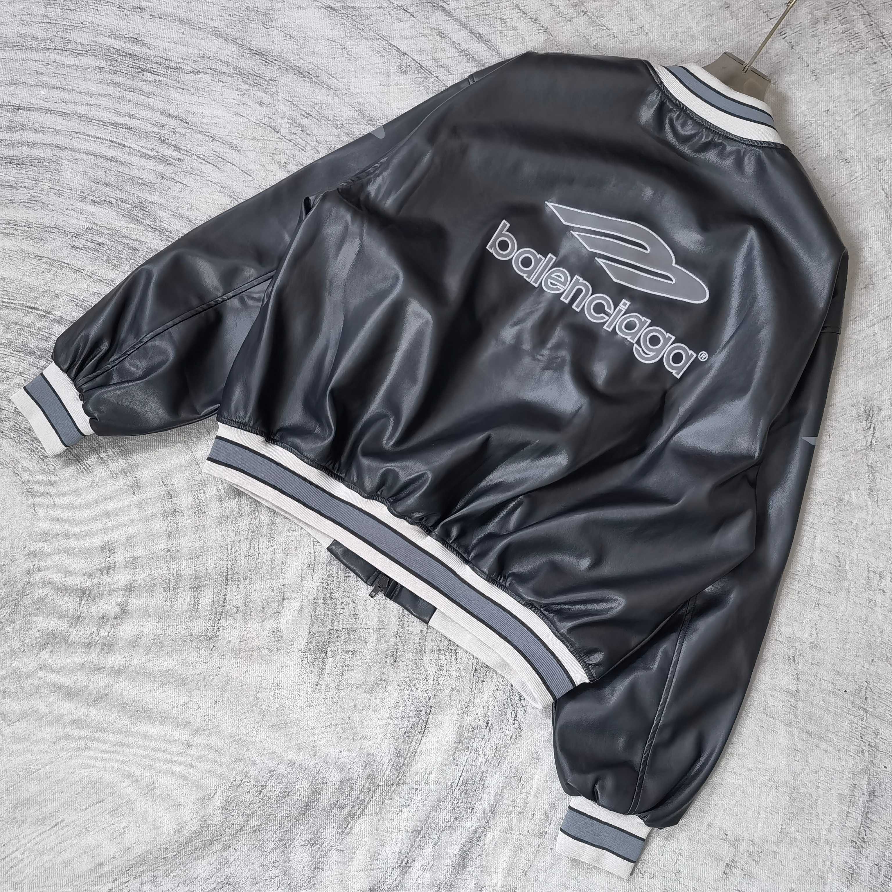 Balenciaga leather bomber jacket angled back view with balenciaga logo and ribbed cuffs
