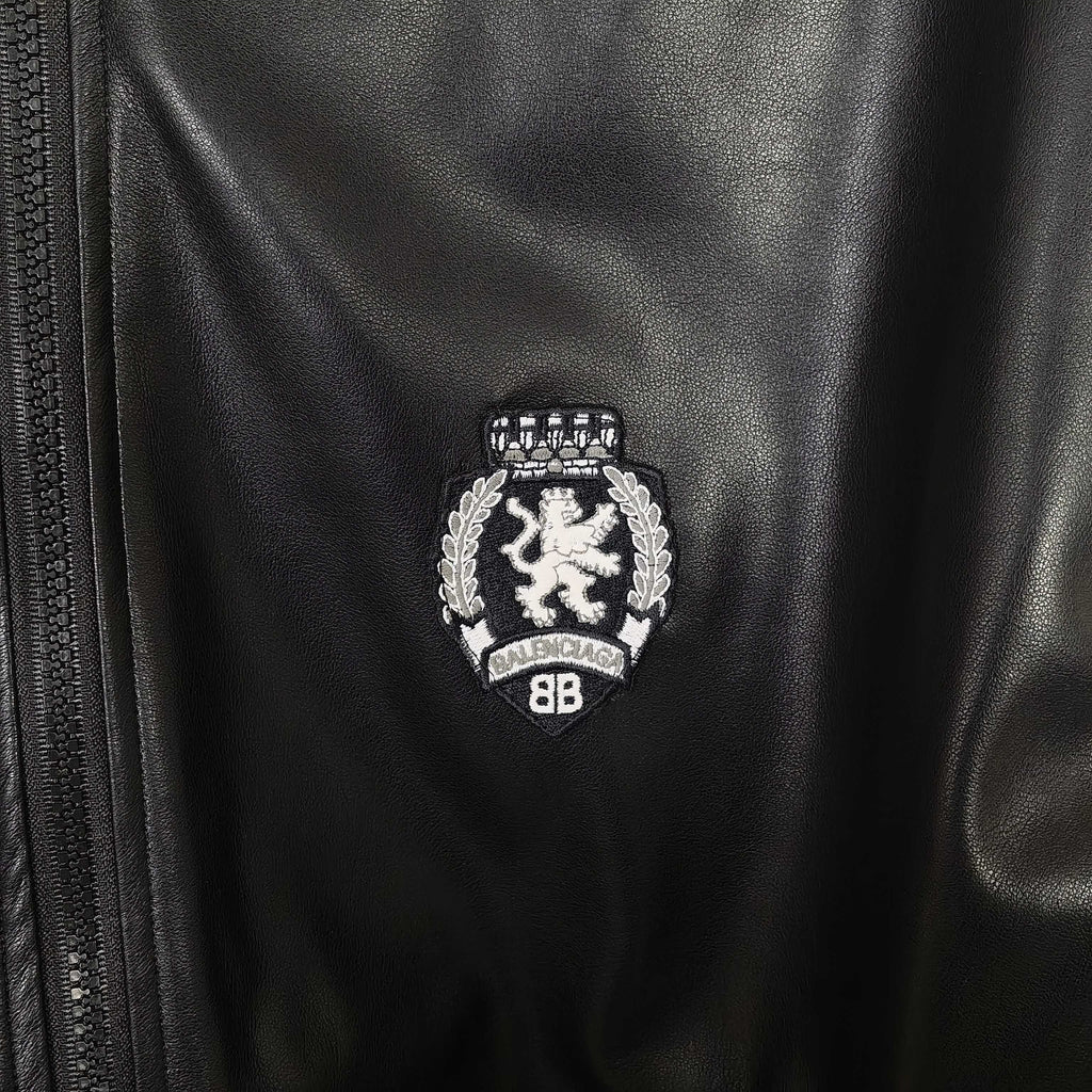 Balenciaga crest emblem on leather bomber jacket near the zipper