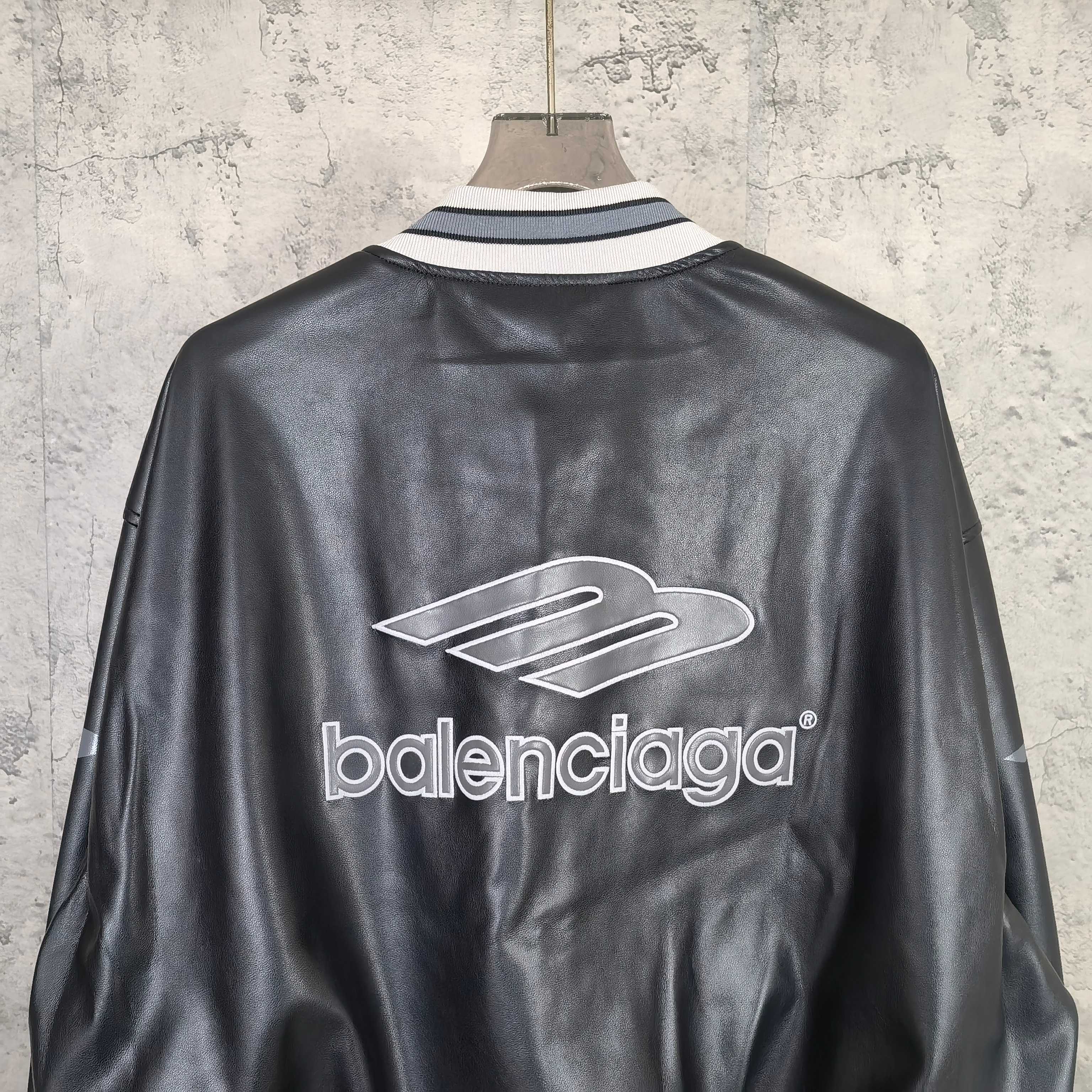 Balenciaga leather bomber jacket back view with large balenciaga logo and rib collar