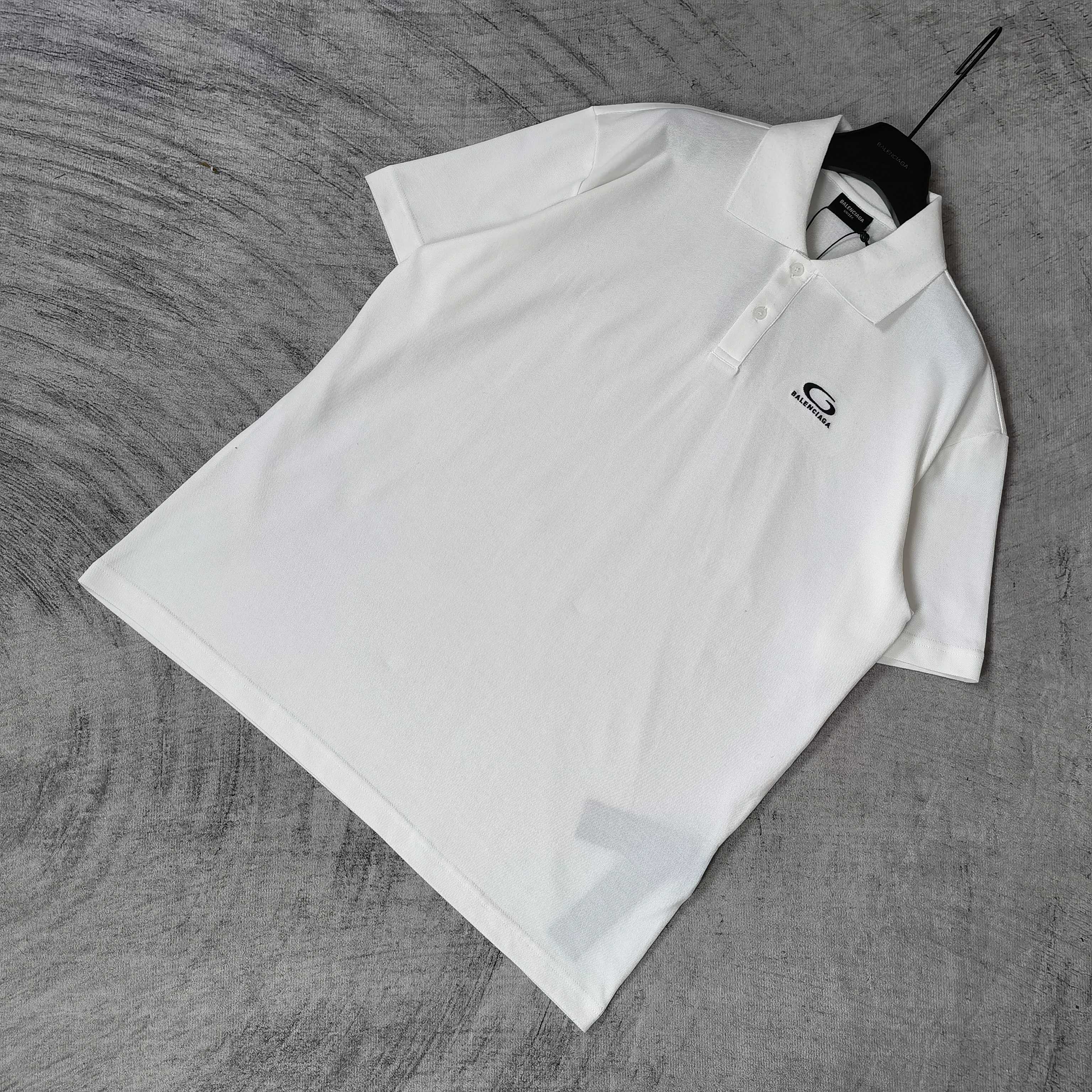 Balenciaga white polo shirt with collar and short sleeves, chest logo embroidery visible
