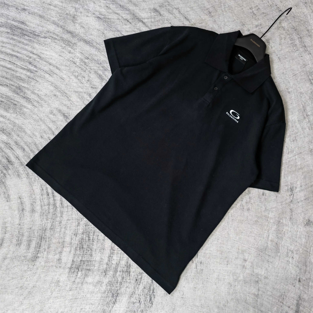 Balenciaga polo shirt, dark color, folded angle view, short sleeves, collar visible