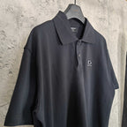 Balenciaga polo shirt, dark color, close front view with collar and logo