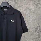 Balenciaga polo shirt, dark color, close front view with chest logo and collar