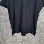 Dark short-sleeve top with curved hem and smooth fabric