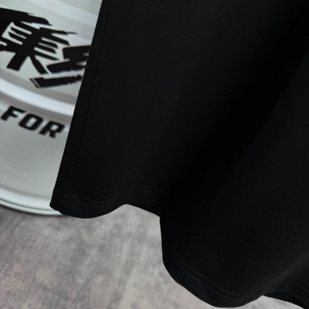 Black T-shirt hem with stitched bottom edge