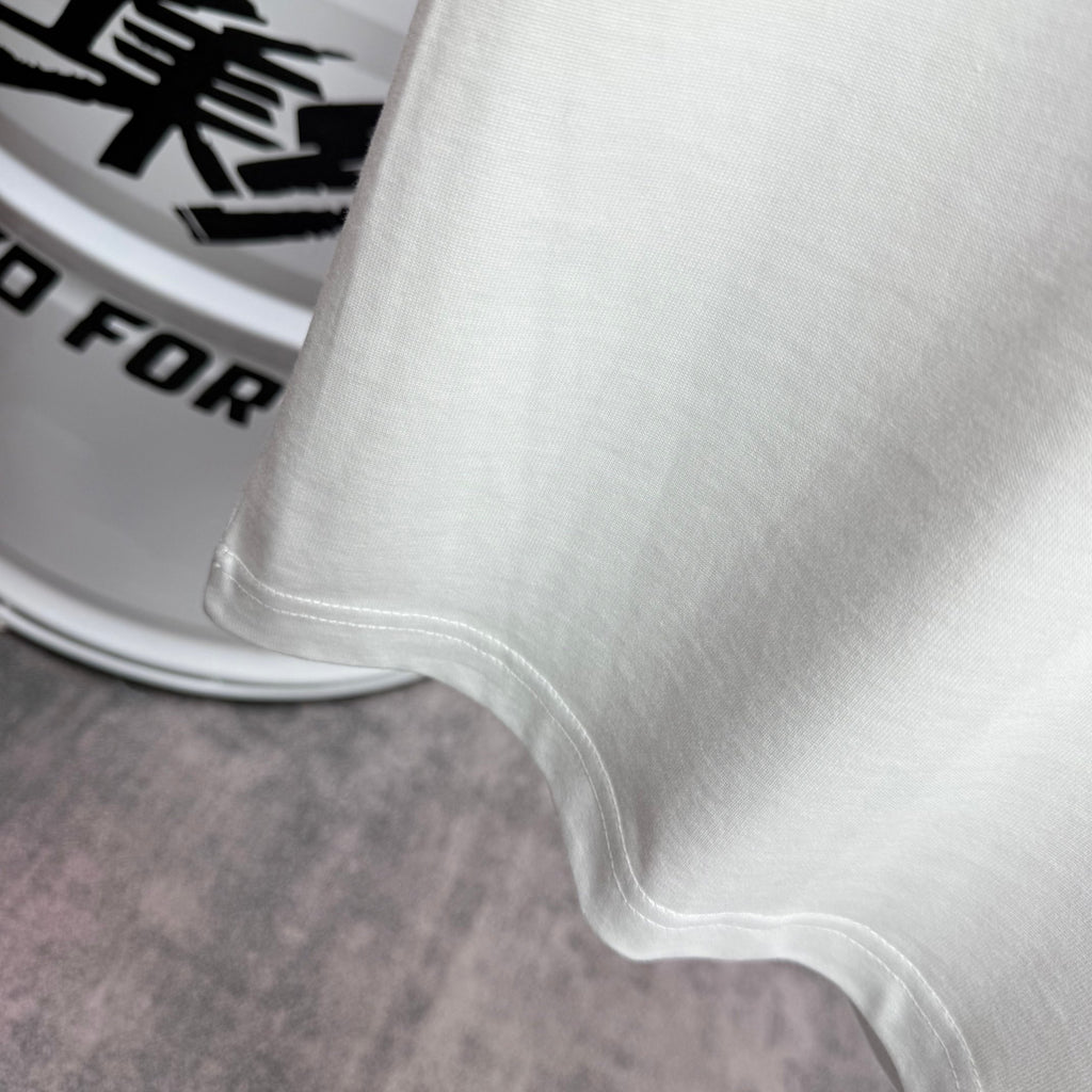 Amiri white T-shirt hem and side seam close-up with clean stitched finish