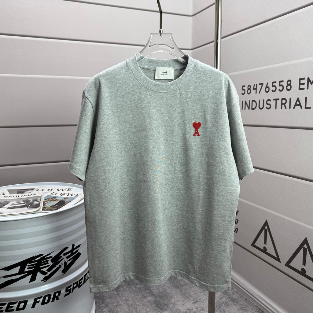 Light mint heather T-shirt with crew neck and small red logo on chest.