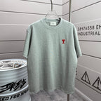 Light mint heather T-shirt with crew neck and small red logo on chest.