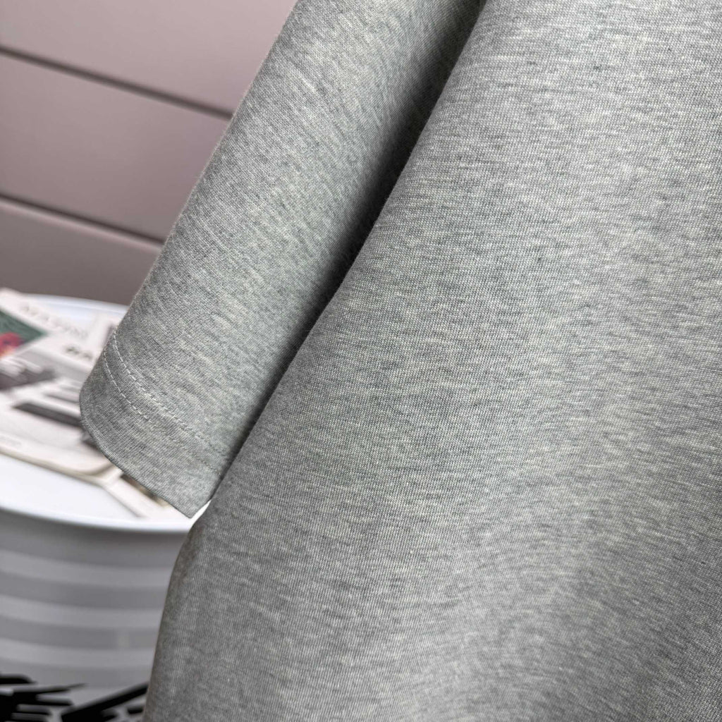 Heather gray T-shirt sleeve close-up with soft knit texture.
