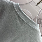 Heather gray T-shirt neckline close-up with ribbed collar edge.