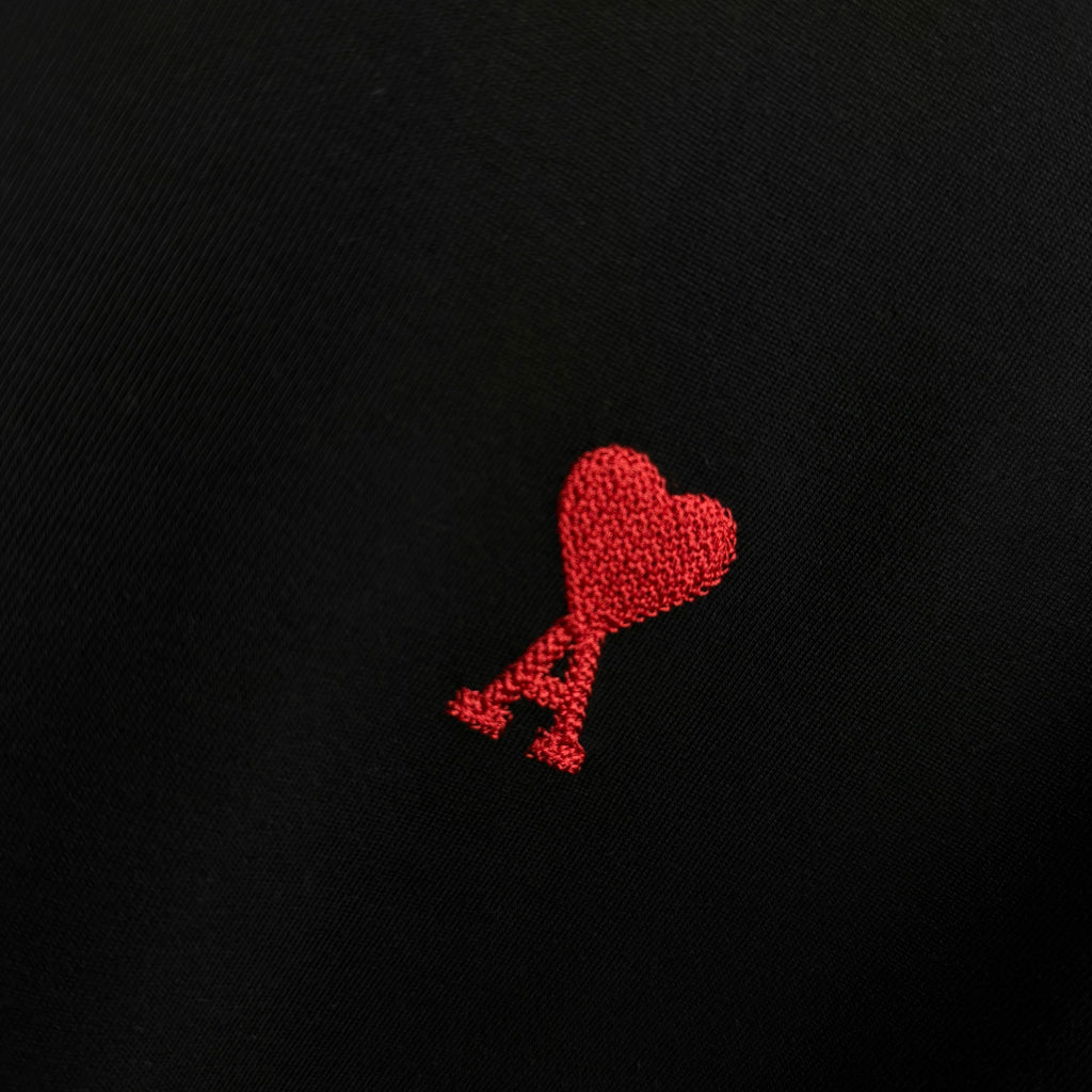 Black T-shirt with red heart logo embroidery