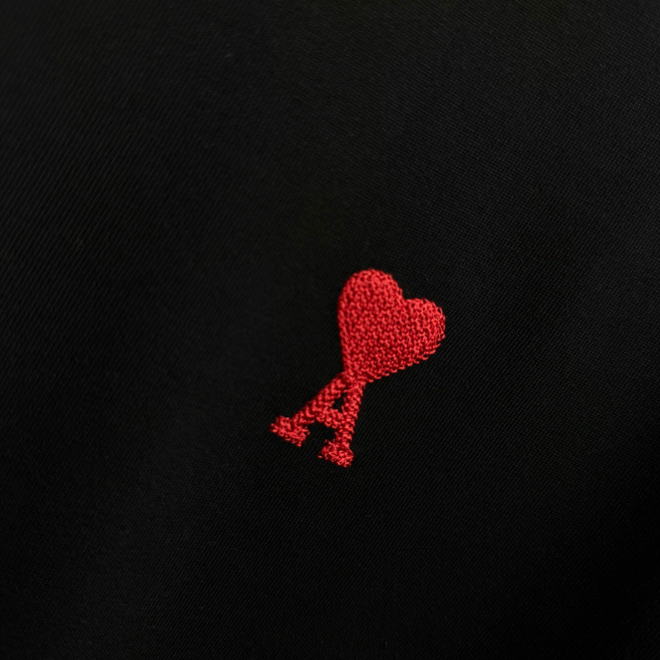 Black T-shirt with red heart logo embroidery