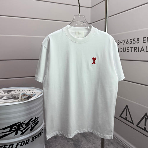 Amiri white short-sleeve T-shirt with small red heart-and-A logo on the chest