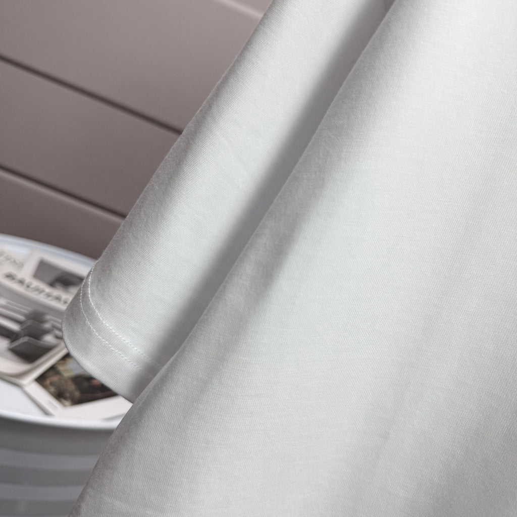 Amiri white T-shirt close-up of sleeve cuff and side seam stitching