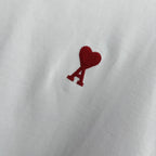 Amiri white T-shirt chest logo featuring red heart above a red A