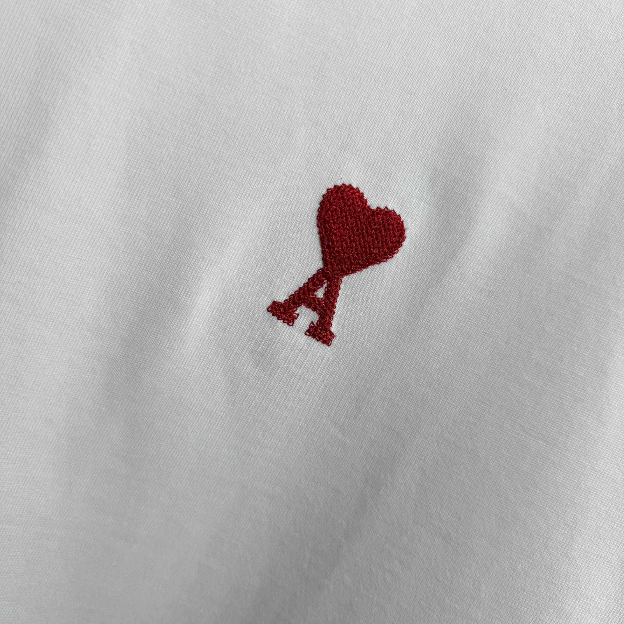 Amiri white T-shirt chest logo featuring red heart above a red A