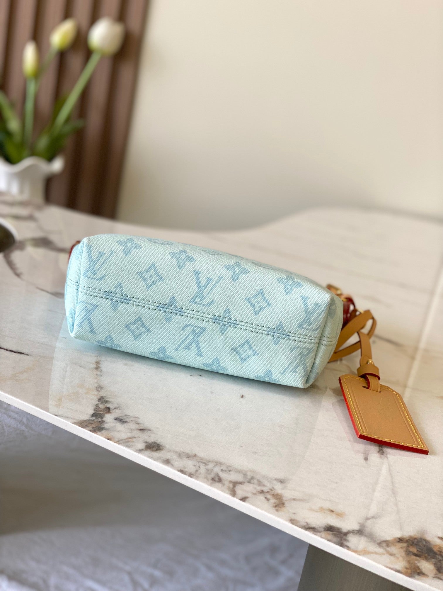 Louis Vuitton light blue monogram clutch-style bag with tan zipper and hanging charm