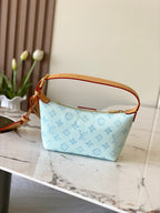 Louis Vuitton light blue monogram handbag with tan top strap and zipper pocket front