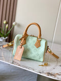 Mint green Louis Vuitton mini handbag with tan leather top handles and gold hardware