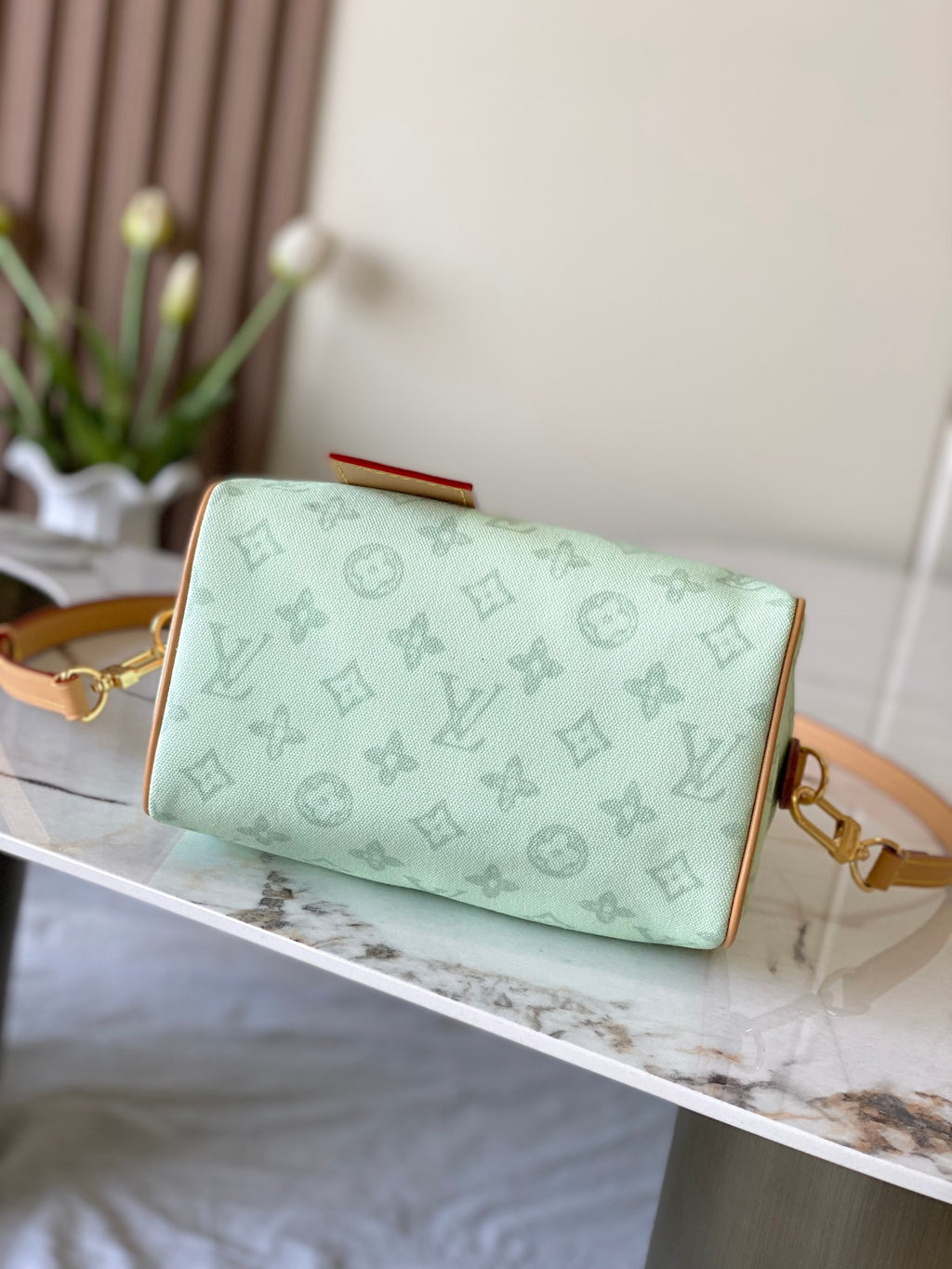 Mint green foldover handbag with tan trim and gold clasp, crossbody strap attached