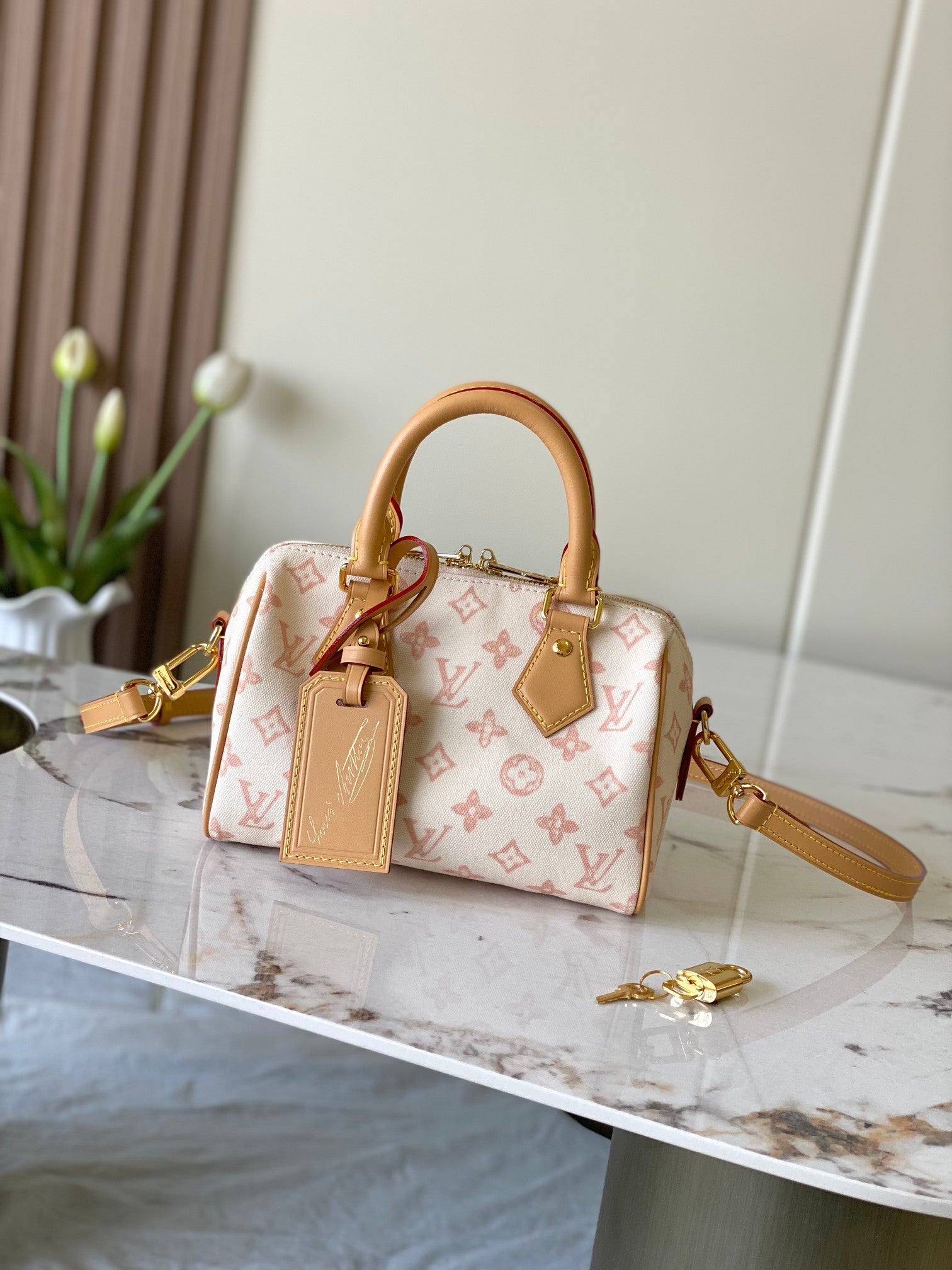 Louis Vuitton monogram handbag with tan leather trim and gold top handles