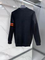Versace knit sweater in dark navy with orange striped sleeve detail, back view