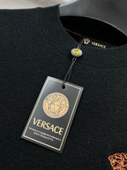 Black knit sweater collar with Versace label and hanging tags