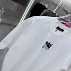 Amiri white T-shirt close-up: crew neck and black chest logo