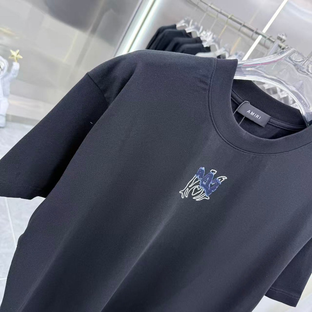 Dark crew-neck T-shirt with blue-and-white chest logo on front