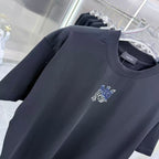 Dark crew-neck T-shirt with blue-and-white chest logo on front