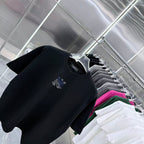 Black crew-neck T-shirt detail with blue-and-white chest logo
