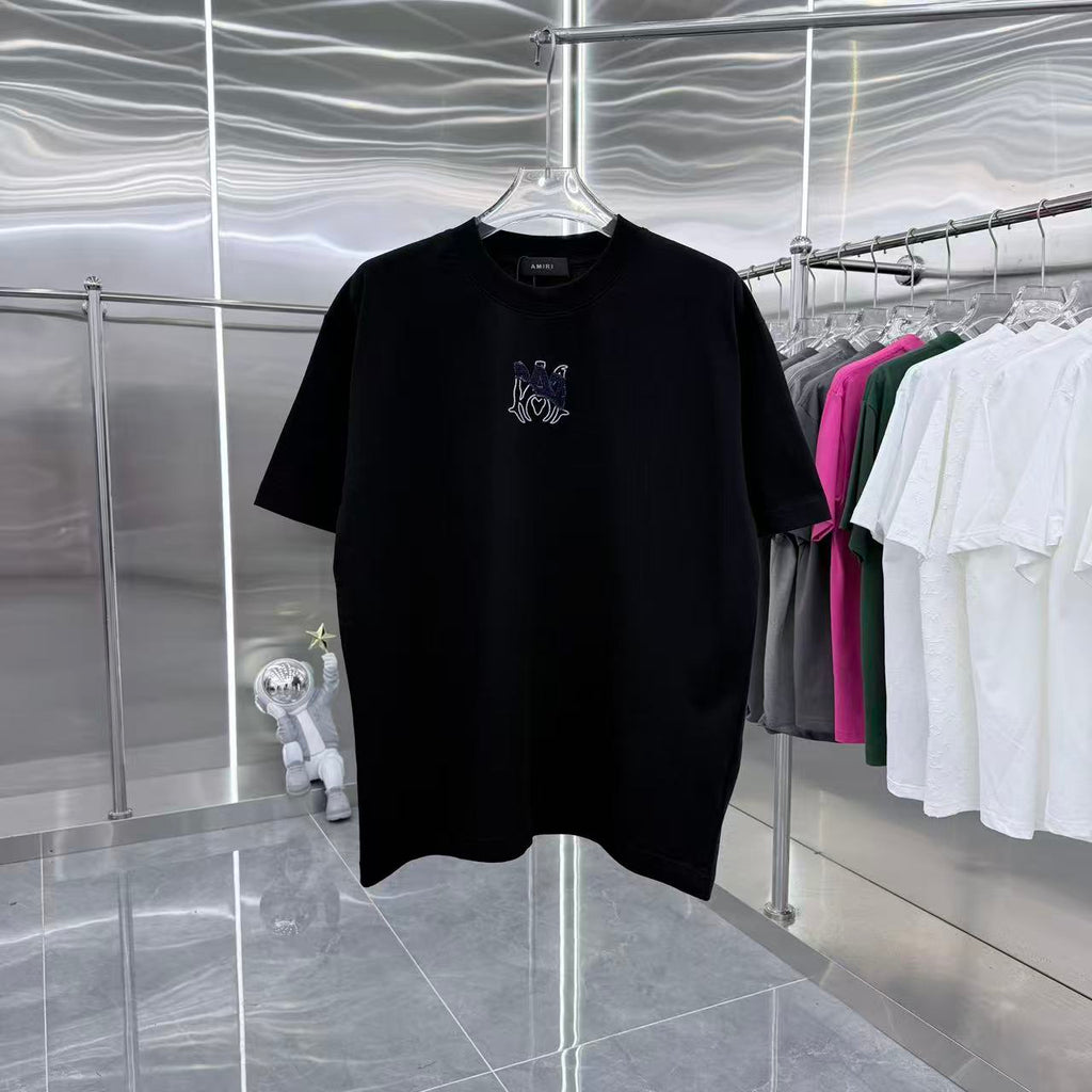 Black crew-neck T-shirt with small chest graphic in blue and white