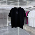 Black crew-neck T-shirt with small chest graphic in blue and white