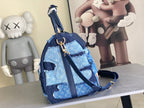 Blue patchwork denim crossbody bag with top handle and adjustable strap, gold hardware