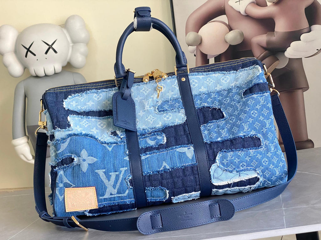 Blue patchwork denim tote bag with top handles and shoulder strap, gold hardware
