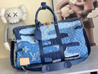 Blue patchwork denim tote bag with top handles and shoulder strap, gold hardware
