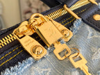 Blue patchwork denim bag close-up of gold logo plate and clasp hardware