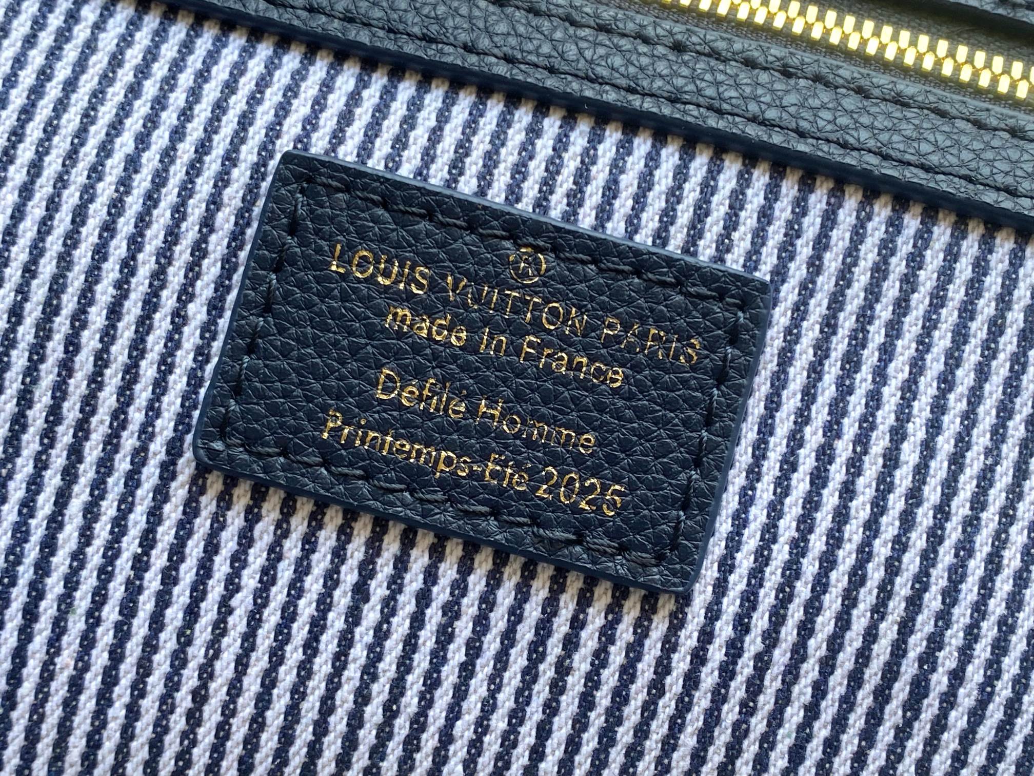 Blue striped lining with dark leather brand label stitched on the bag interior