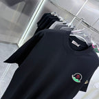 Black short-sleeve T-shirt with round neckline and Moncler crest emblem