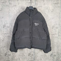 Long hooded puffer jacket in dark gray with front button placket and chest logo