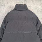 Long hooded puffer jacket in dark gray, back view with high neck
