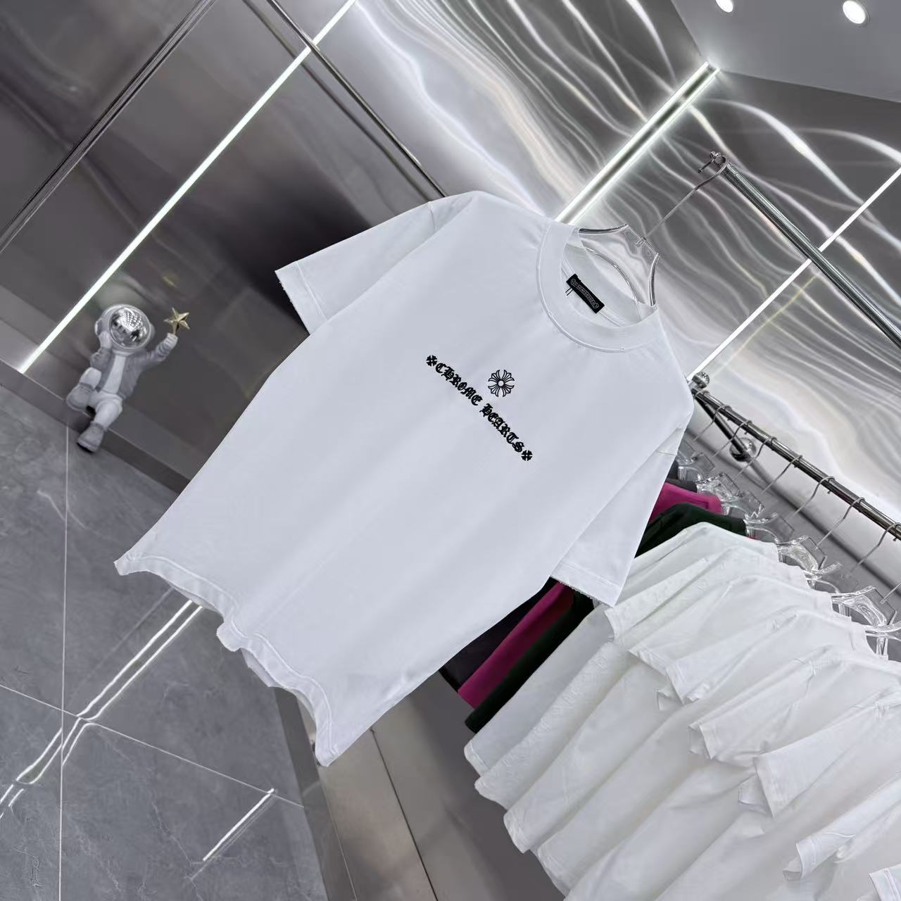 White short-sleeve T-shirt laid flat, chest graphic logo
