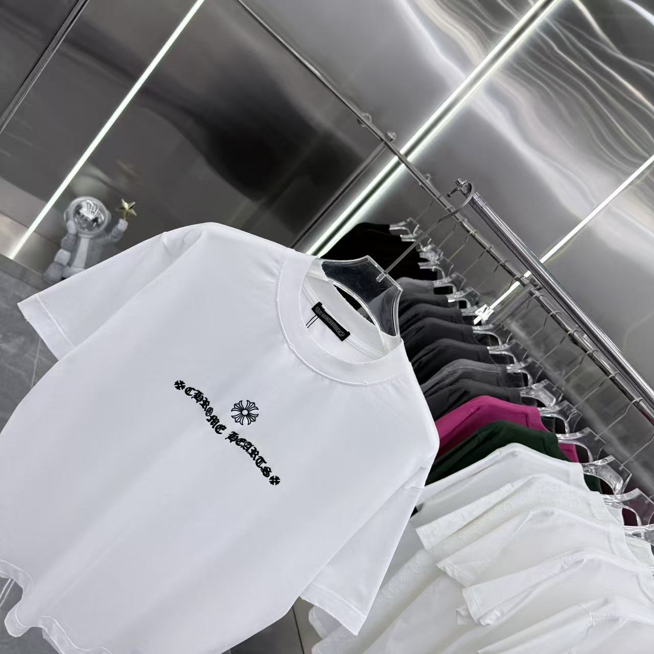 White short-sleeve T-shirt angled view, chest graphic logo