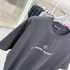Black short-sleeve T-shirt with crew neckline and small chest graphic print
