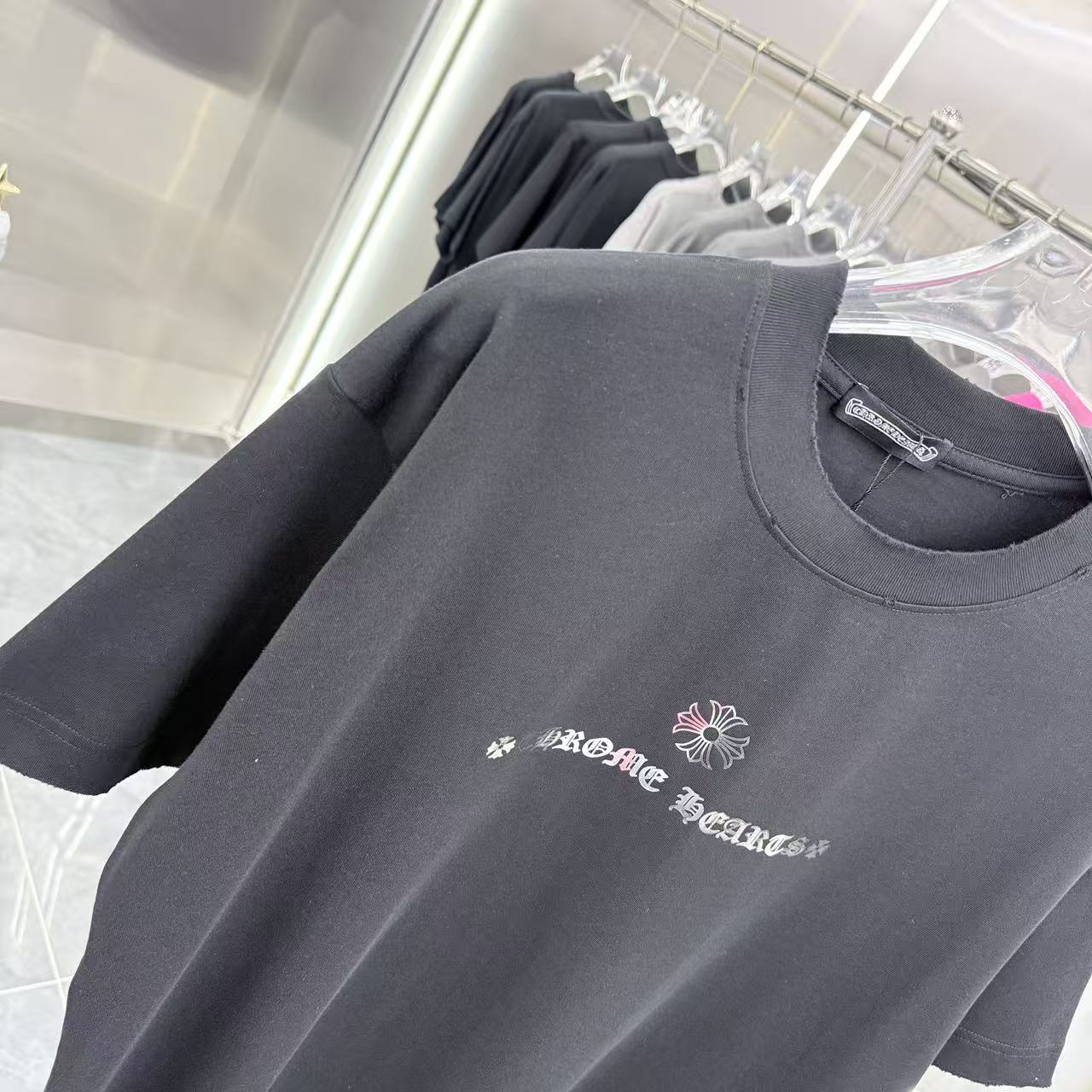Black short-sleeve T-shirt with crew neckline and small chest graphic print