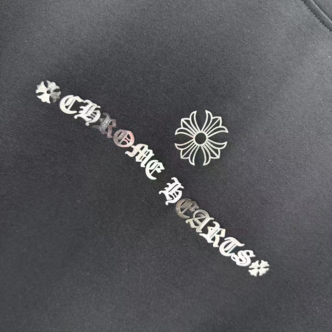Black T-shirt close-up of chest graphic emblem and decorative text