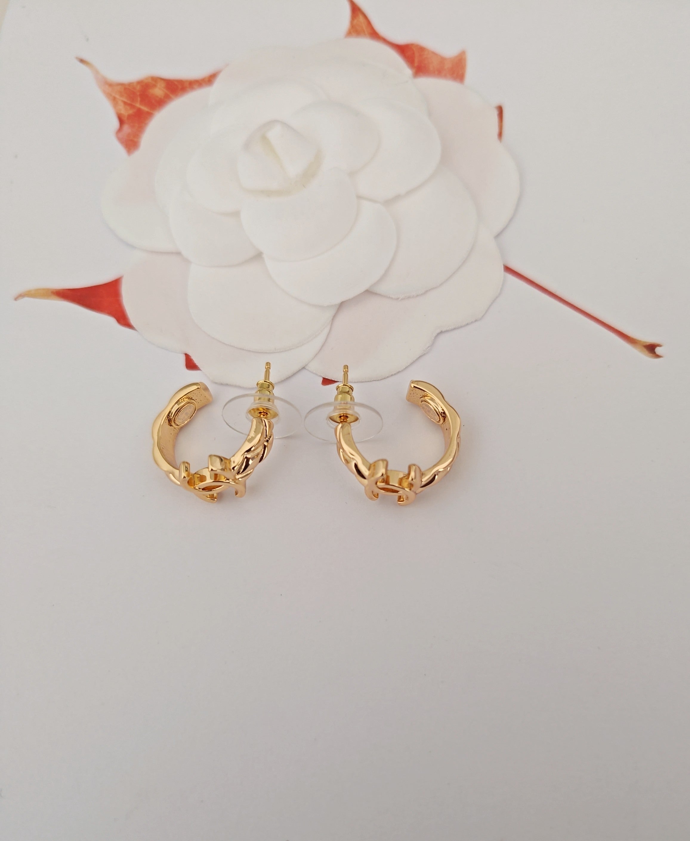 Gold-tone Chanel hoop earrings with CC logo and charm accents