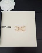 Gold-tone Chanel C-hoop earrings with small logo charm